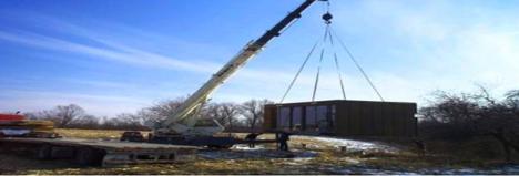 Composite structure being lifted by crane on site