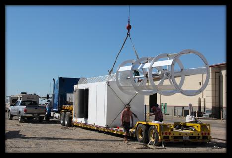 Full-scale MAG-LEV turbine being crane-loaded onto flatbed with composite modular unit
