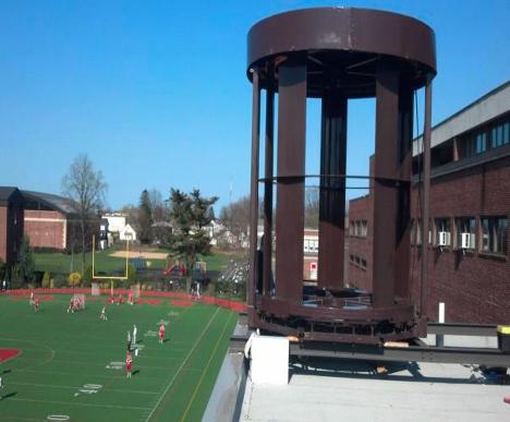 Sylentra MAG-LEV turbine on school rooftop with sports field below
